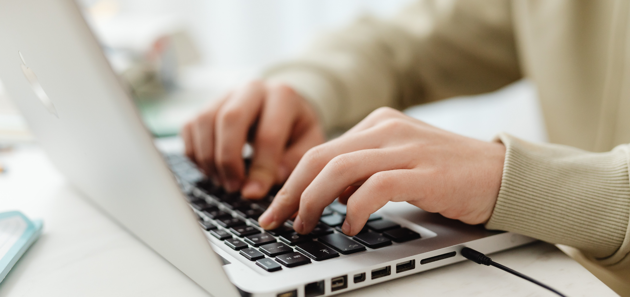 hands typing on a laptop for bookkeeping